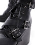 Фото #2 товара ASOS DESIGN wedge heeled boots in black faux leather with buckle detail