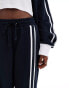 Фото #4 товара COLLUSION Unisex relaxed joggers in navy and brown co-ord