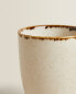 Porcelain mug with antique finish rim