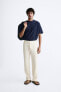 TEXTURED PLEATED TROUSERS