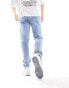 ASOS DESIGN skinny jeans with heavy rips in light wash blue