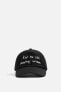 CAP WITH EMBROIDERED SLOGAN