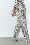 Straight fit snakeskin print trousers