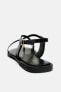 Strappy flat slider sandals with metal embellishment