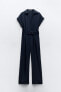 Belted jumpsuit with turn-up trims