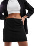 Edited tailored mini skirt in black