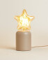 Children’s table lamp with star light bulb