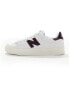 New Balance 100 trainers in white and navy