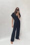 Belted jumpsuit with turn-up trims
