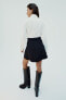 Mini skirt with woven belt