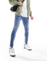 Фото #2 товара ASOS DESIGN spray on jeans with power stretch in tinted mid wash blue