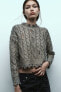 Cable-knit metallic sweater