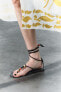 Lace-up leather sandals with beads