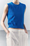 Plain knit top with ribbed trims