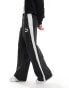 Фото #1 товара Puma T7 oversized woven joggers in black