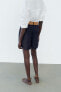 DARTED BERMUDA SHORTS WITH BELT