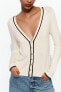 Knit jacket with piped seams