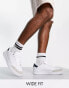 Фото #1 товара Truffle Collection wide fit lace up trainers in white/navy