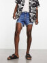 ASOS DESIGN shorter length denim shorts in midwash with rip detail and raw hem