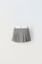 Box pleat skirt with slogan waistband