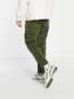 ASOS DESIGN tapered cord trousers with busted seams in green