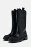 Flat boots with rubberised sole