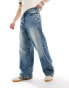 Фото #1 товара Bershka super baggy jeans in washed mid blue