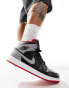 Air Jordan 1 mid trainers in black and red